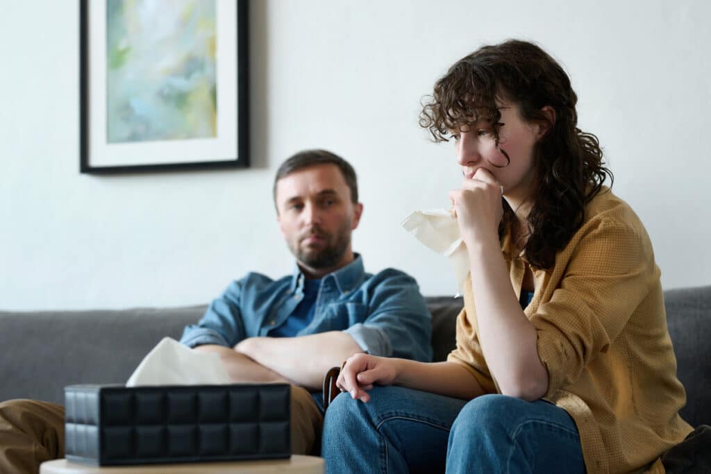 Depressed woman visiting psychologist with her husband